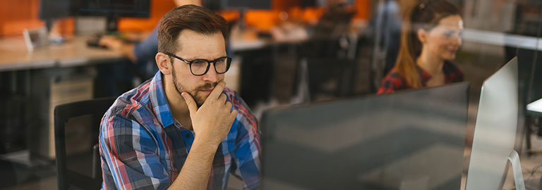 Man working on a computer in an office.